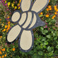 The Shade-A-Rella Super Sale! 24 inch Bee with black frame and light yellow 90% shade cloth adds charm among green plants and vibrant blooms, while the subtle holder supports overhead plant shade.